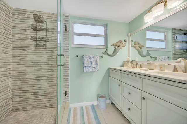 a bathroom with a granite countertop sink a toilet and shower