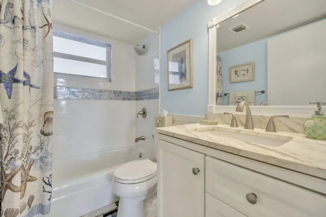 a bathroom with a sink mirror and vanity