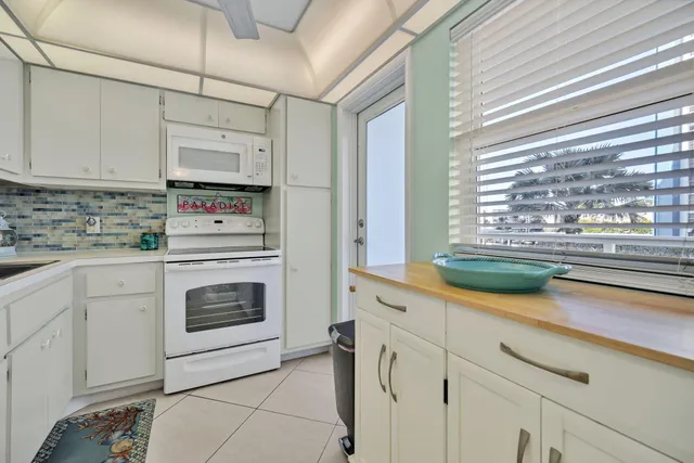 a white refrigerator freezer sitting inside of a kitchen