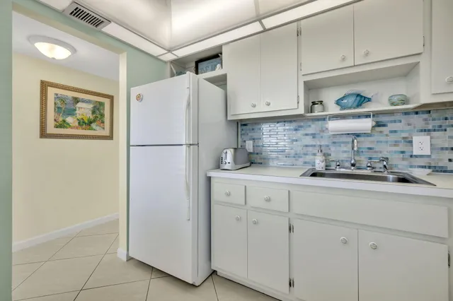 a utility room with cabinets washer and dryer