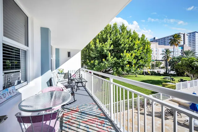 a balcony with table and chairs