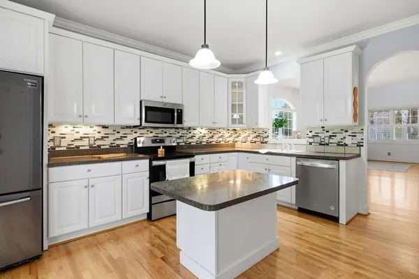 a kitchen with granite countertop a sink and a stove