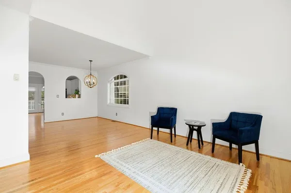 a living room with furniture and a piano table