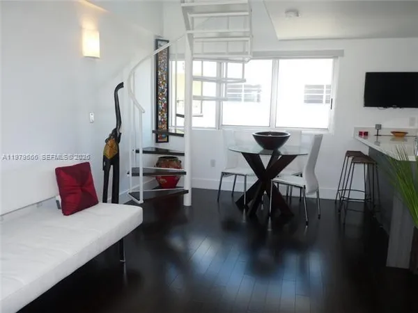 a view of a dining room with furniture window and wooden floor