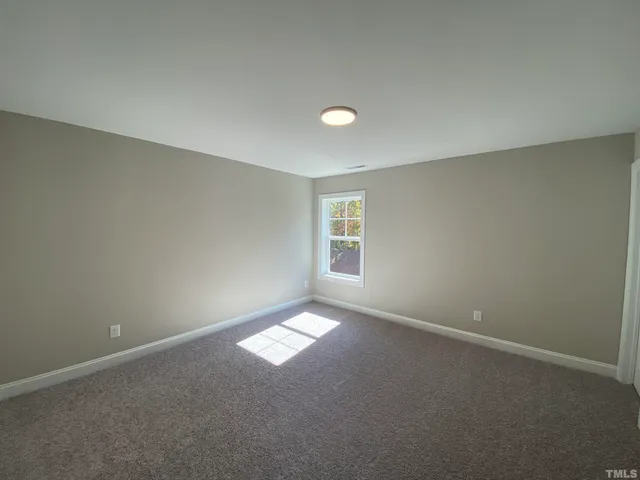 an empty room with a empty space and a window