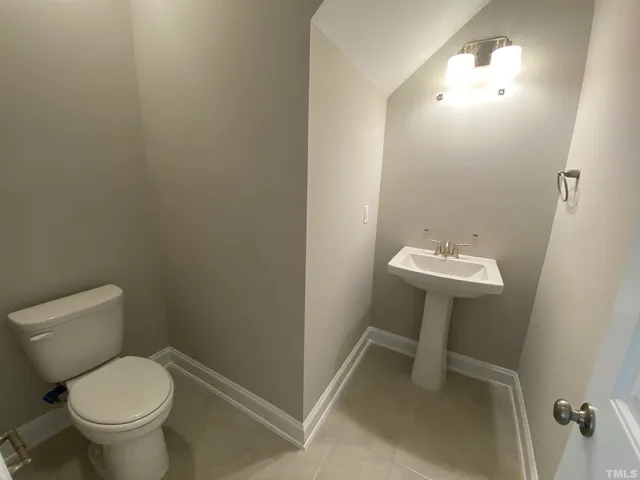a bathroom with a sink toilet and a mirror
