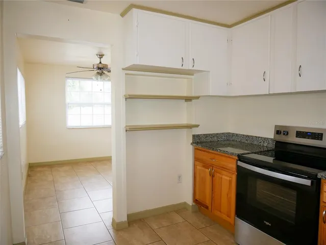 a kitchen with granite countertop a stove and a sink