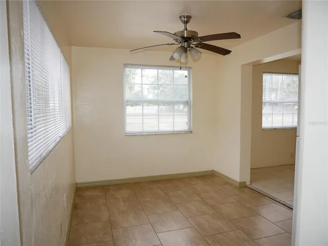 a view of a livingroom with a ceiling fan and window