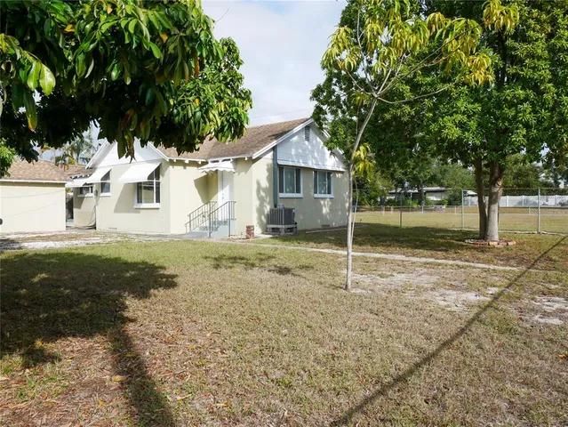 a backyard of a house with large trees