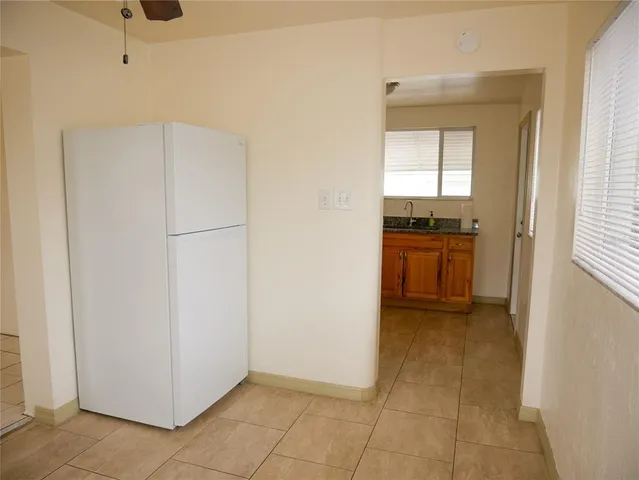 a view of a kitchen with a refrigerator cabinets and a window