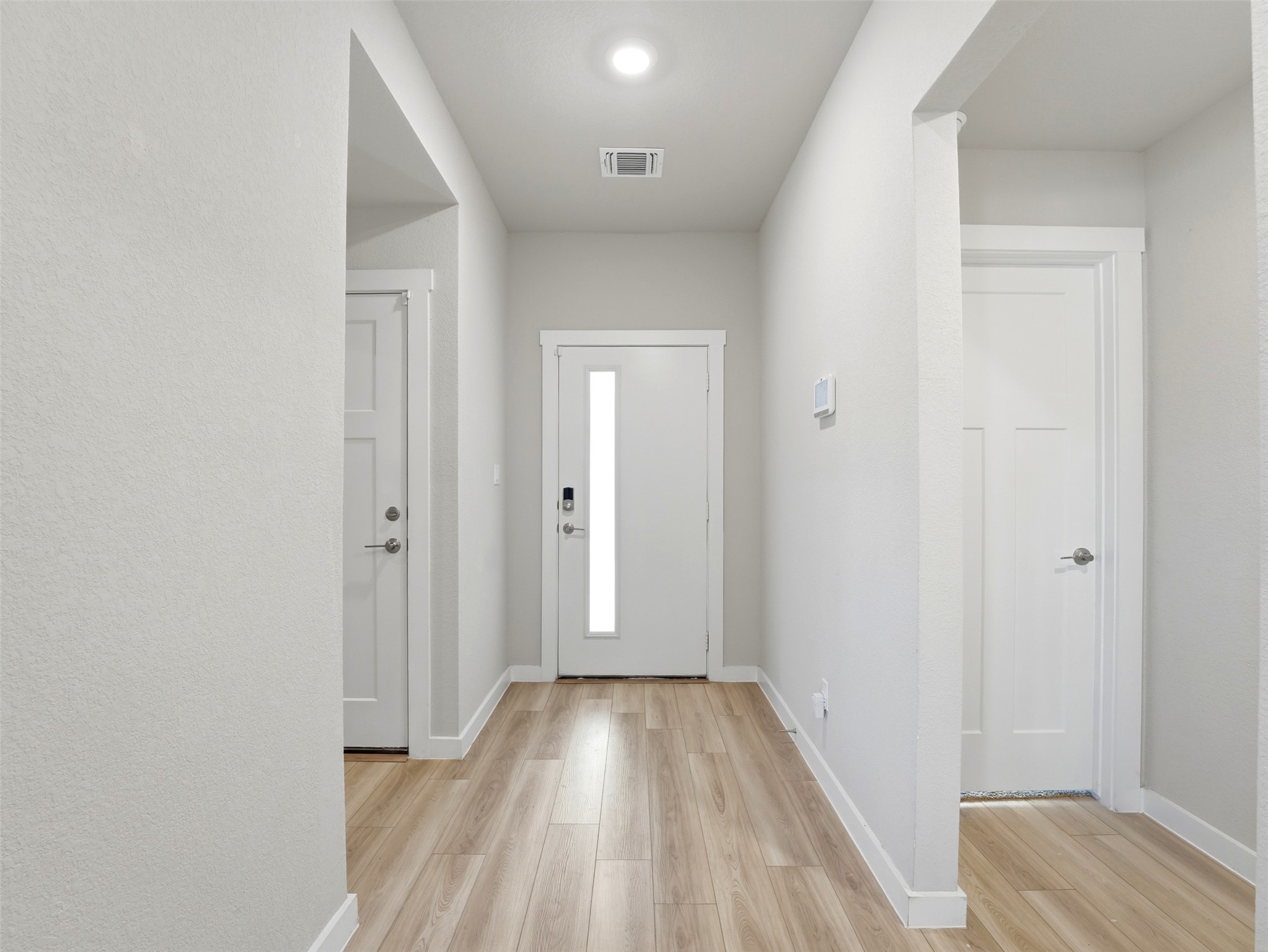 1024 Tipton Street Georgetown, TX 78633 - Photo 4 of 32 Enter into a modern entryway with durable wood-look flooring and clean architectural lines.