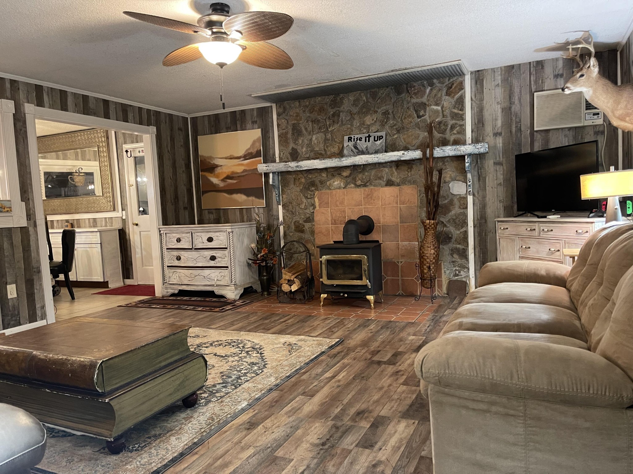 1522 Turkey Creek Road Tellico Plains, TN 37385 - Photo 14 of 34 a living room with furniture a flat screen tv and kitchen view