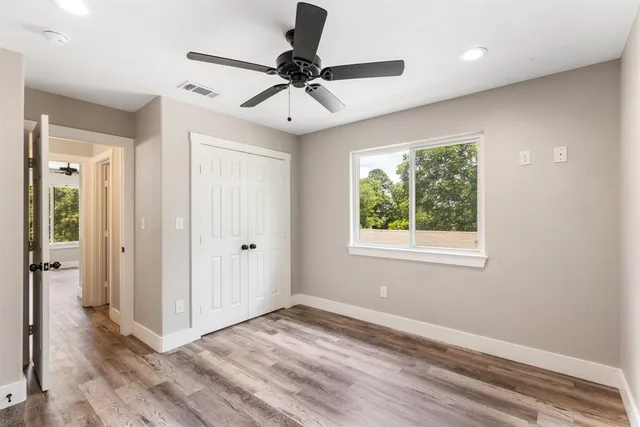 a view of a livingroom with a ceiling fan and window