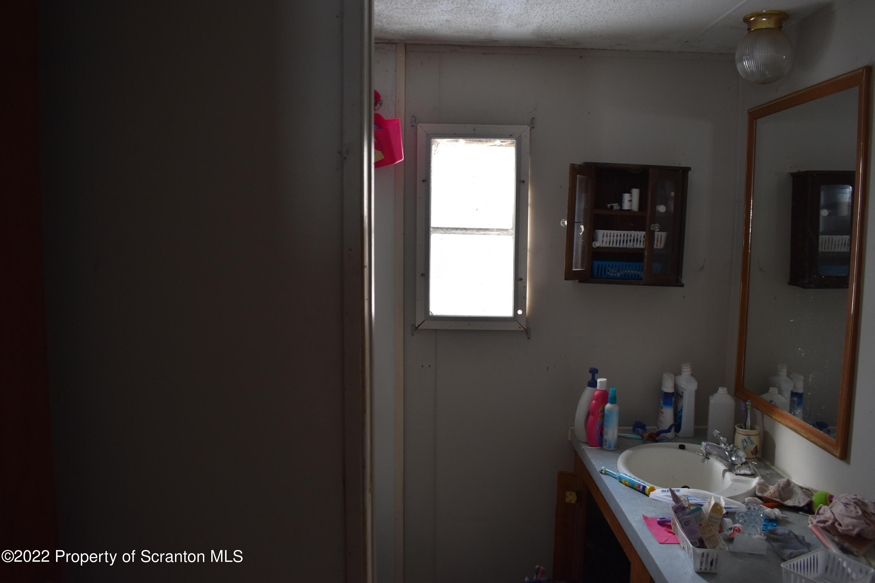 422 Ervine Road Montrose, PA 18801 - Photo 13 of 14 a bathroom with a toilet sink and mirror