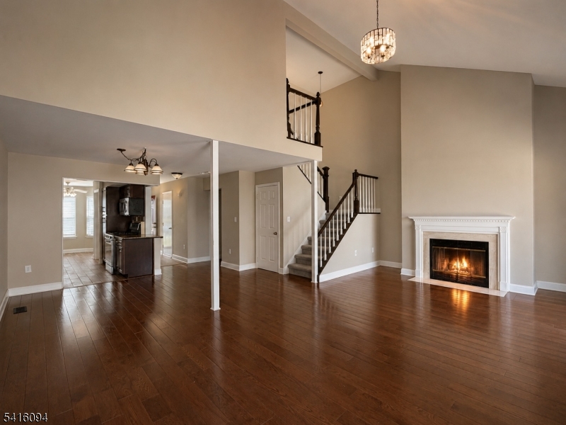 91 Delaware Lane, Unit 91 Somerville, NJ 08876 - Photo 11 of 32 a view of a livingroom with wooden floor and a fireplace