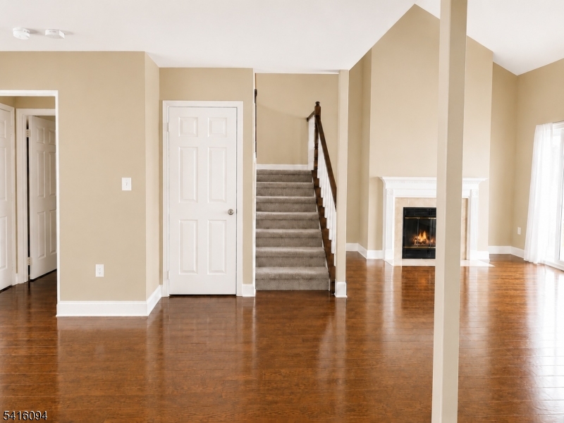 91 Delaware Lane, Unit 91 Somerville, NJ 08876 - Photo 13 of 32 a view of empty room with wooden floor