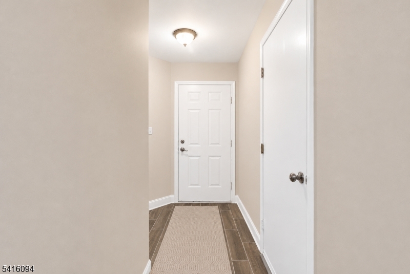 91 Delaware Lane, Unit 91 Somerville, NJ 08876 - Photo 3 of 32 a view of a hallway with wooden floor