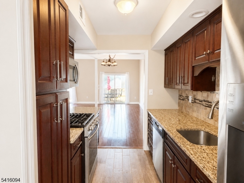 91 Delaware Lane, Unit 91 Somerville, NJ 08876 - Photo 8 of 32 a kitchen with granite countertop a sink stove and refrigerator