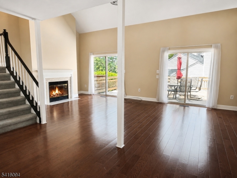 91 Delaware Lane, Unit 91 Somerville, NJ 08876 - Photo 10 of 32 a view of an empty room with wooden floor fireplace and a window
