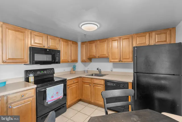 a kitchen with a sink a stove a refrigerator and cabinets