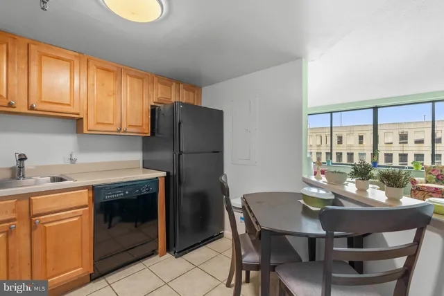 a kitchen with a table chairs and refrigerator
