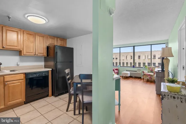 a kitchen with a refrigerator a stove and a sink with cabinets