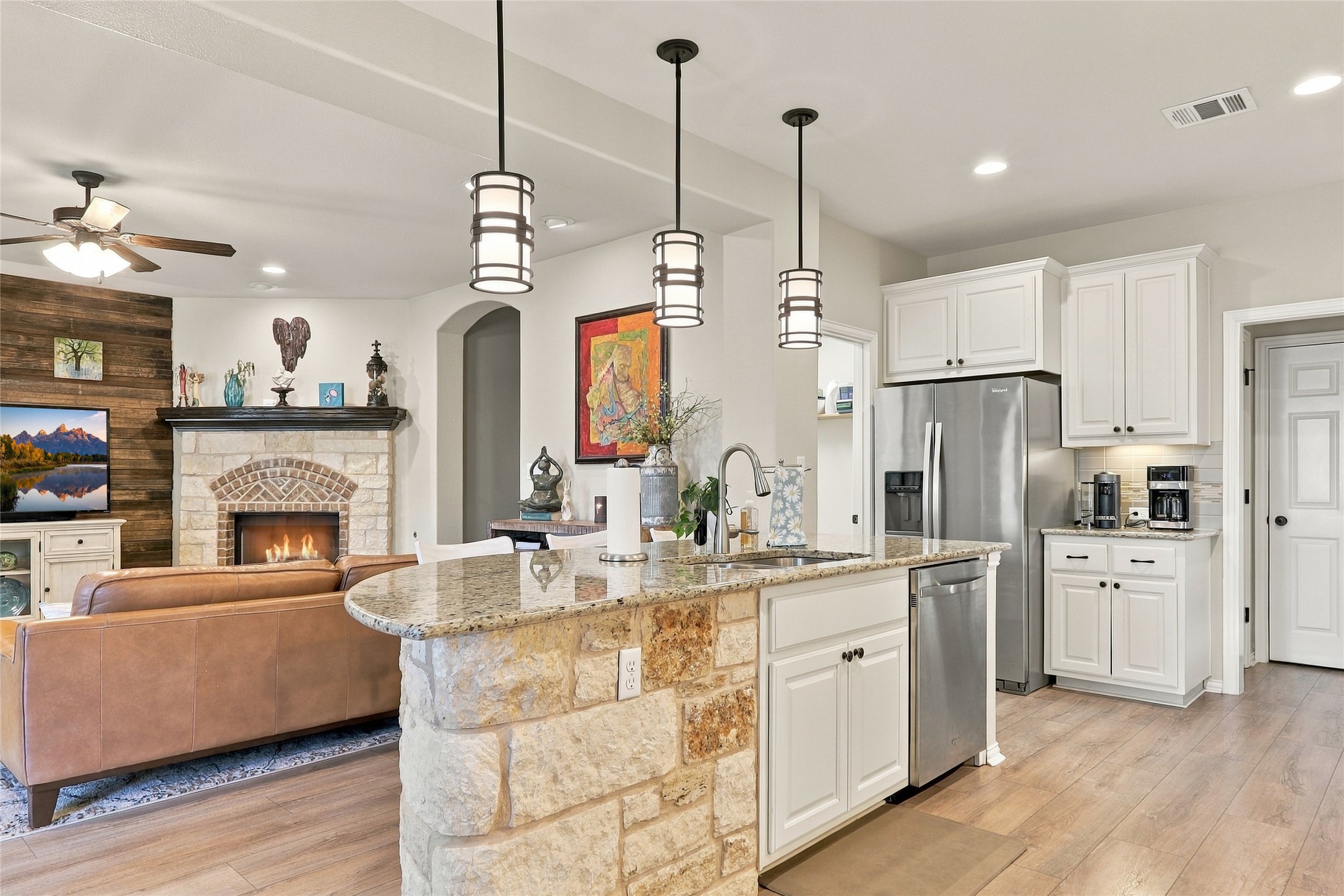 320 Fort Cobb Way Georgetown, TX 78628 - Photo 4 of 37 Gleaming granite countertops and a stone-faced breakfast bar anchor this thoughtfully designed kitchen workspace.