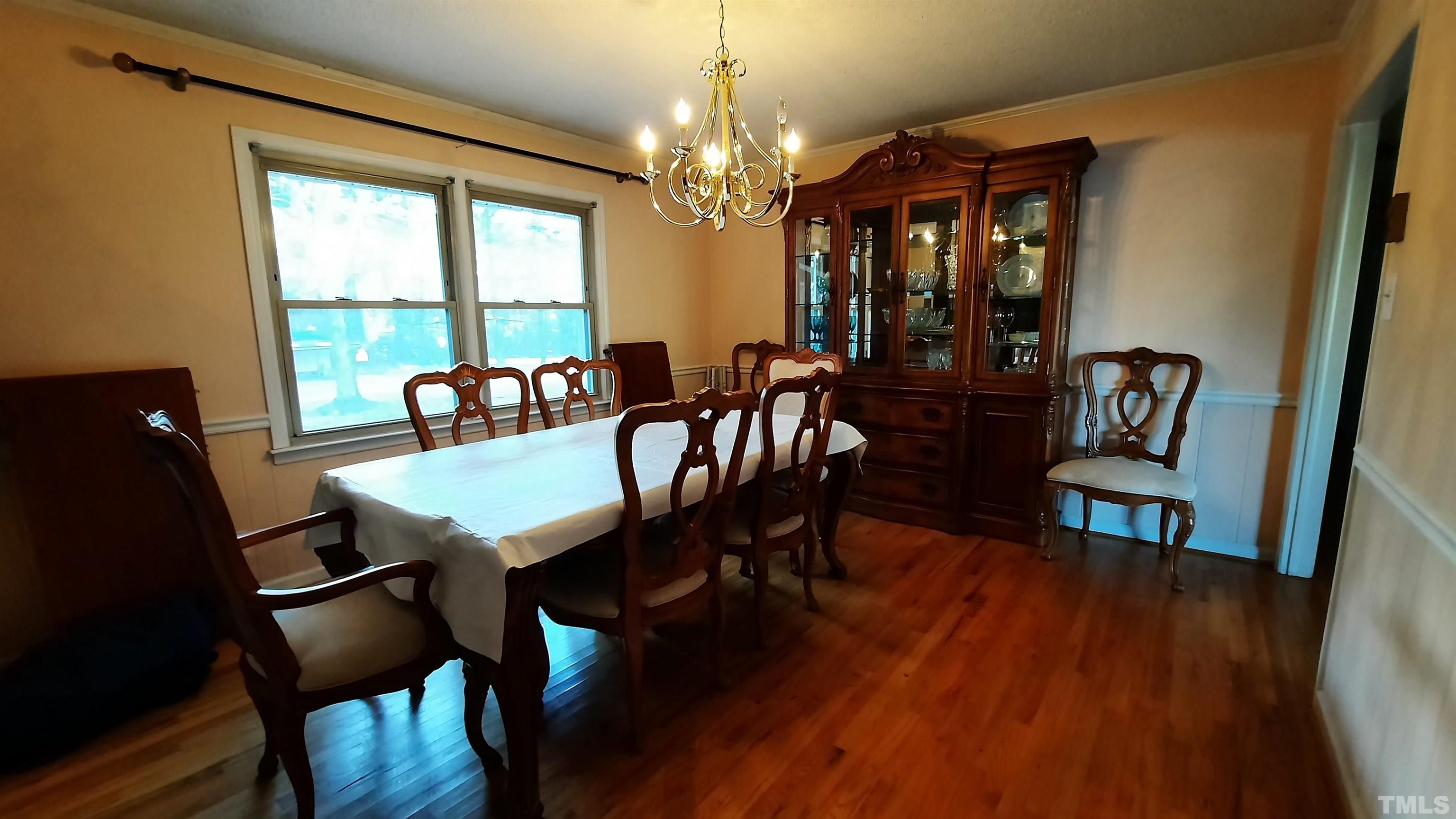 2117 Shaw Road Durham, NC 27704 - Photo 11 of 17 a view of a dining room with furniture window and wooden floor