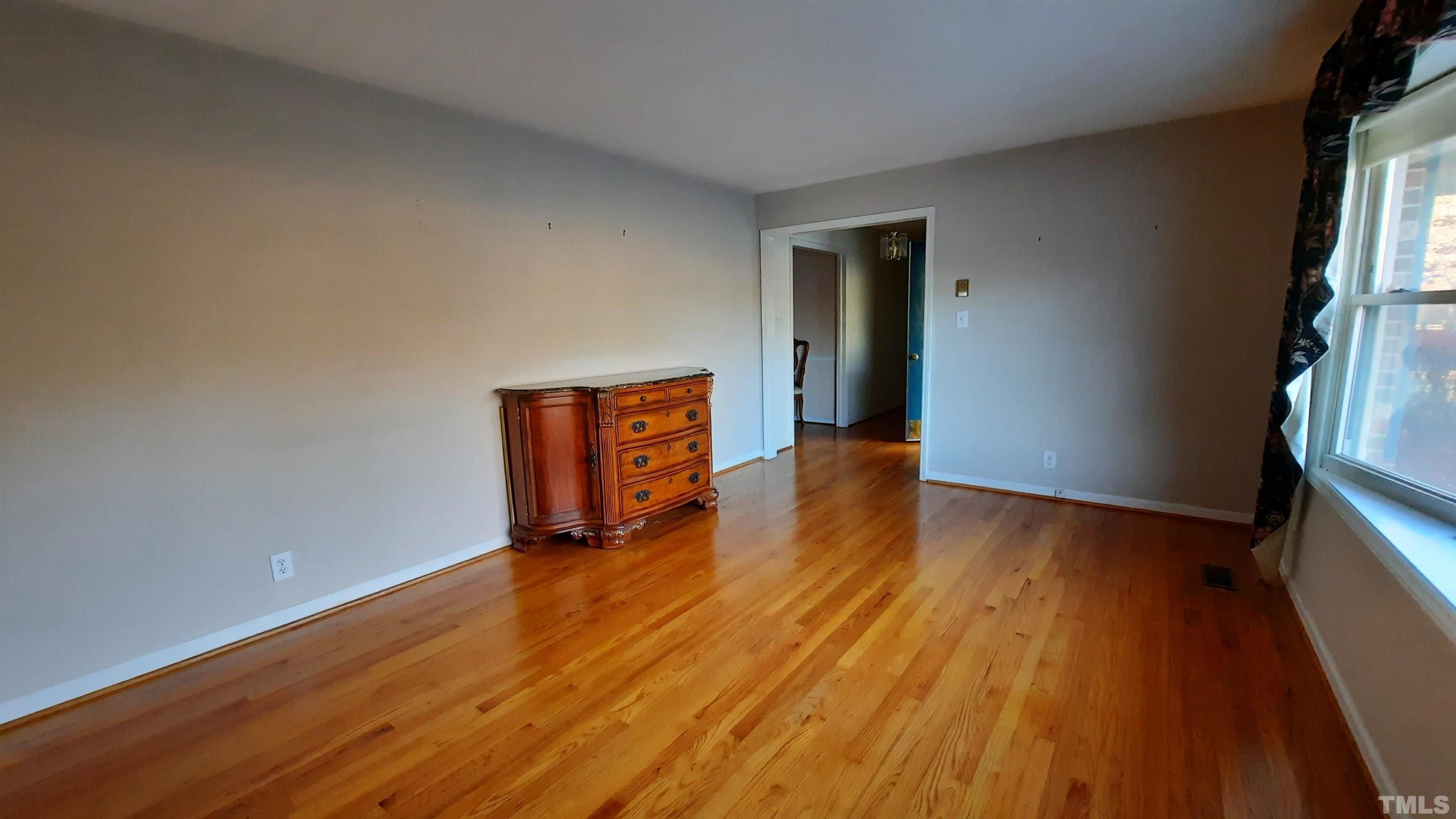2117 Shaw Road Durham, NC 27704 - Photo 16 of 17 a view of an empty room with wooden floor and a window