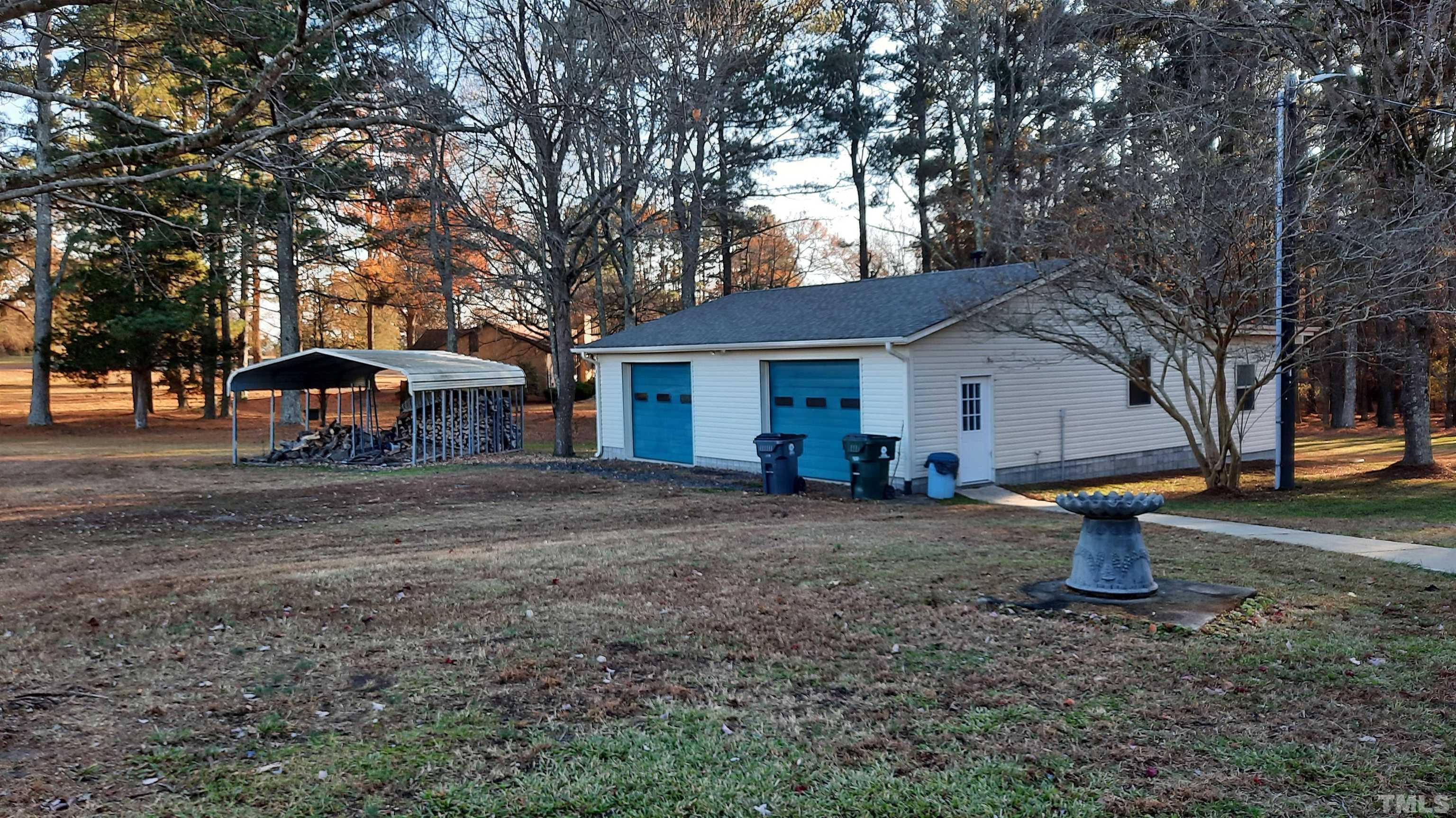 2117 Shaw Road Durham, NC 27704 - Photo 8 of 17 a view of a house with backyard and trees
