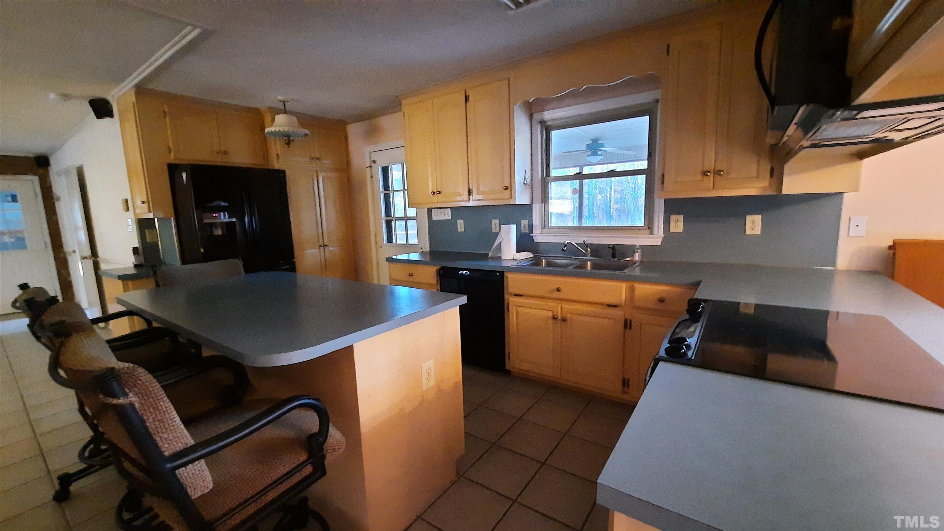 2117 Shaw Road Durham, NC 27704 - Photo 10 of 17 a kitchen with a sink appliances and cabinets