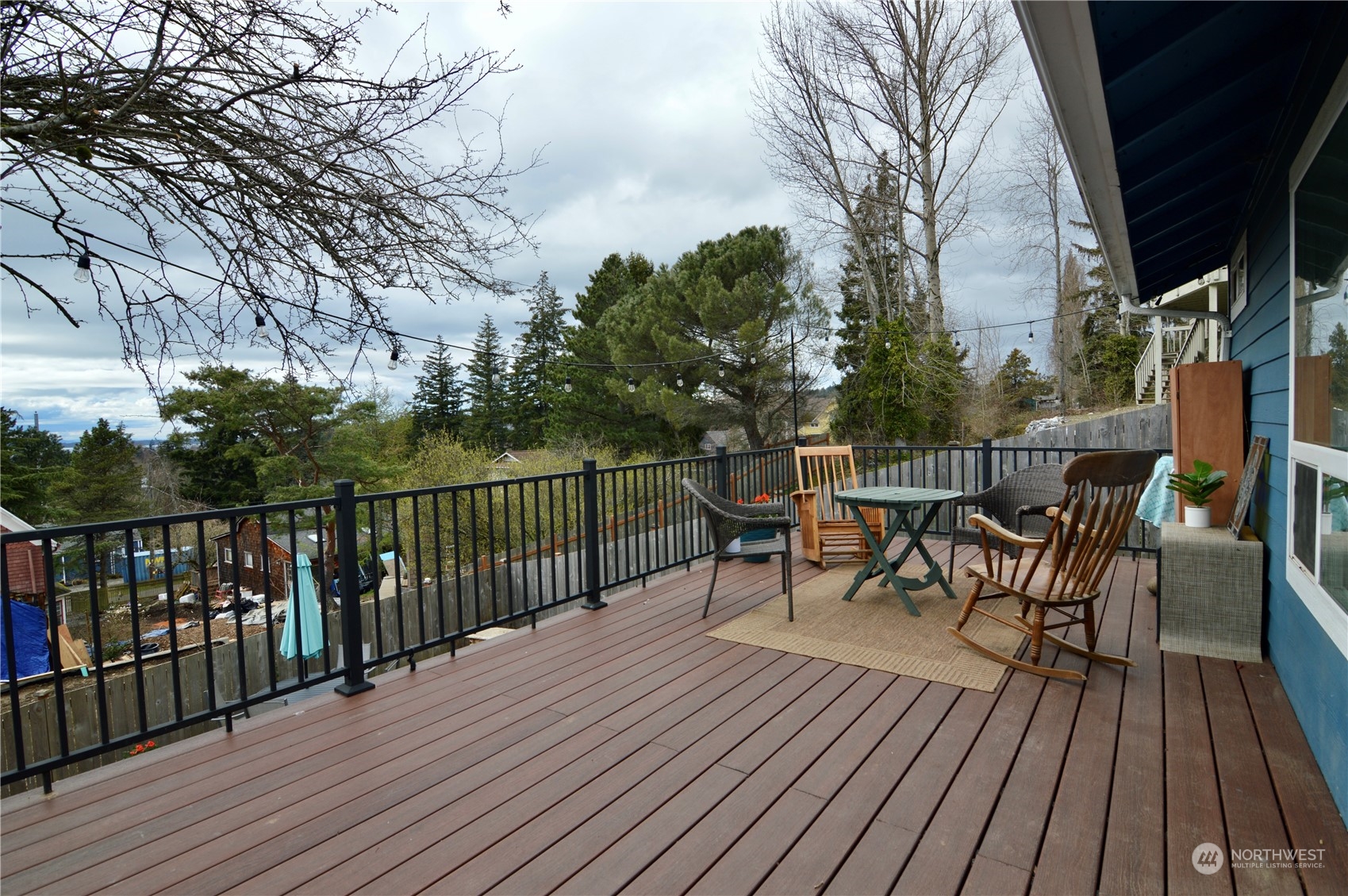 1818 35th Street Bellingham, WA 98229 - Photo 26 of 39 a view of a roof deck with table and chairs and wooden floor
