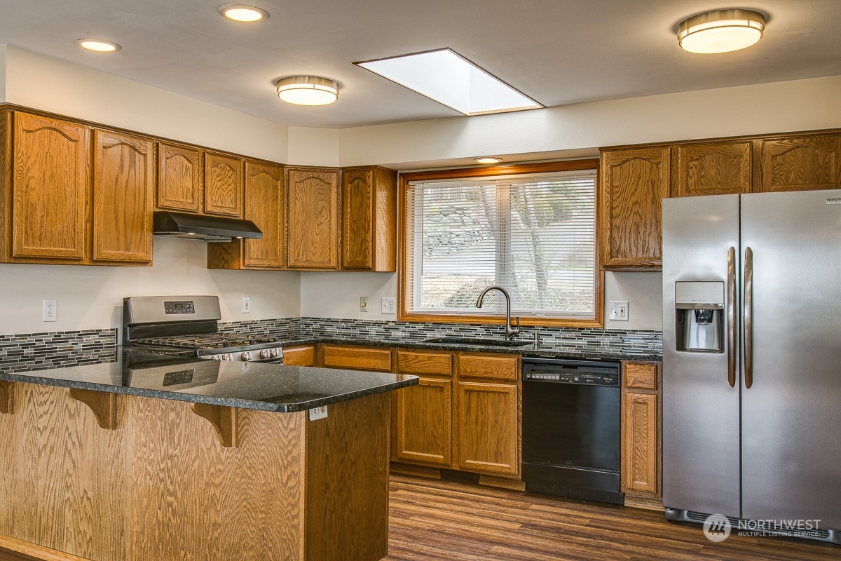 1818 35th Street Bellingham, WA 98229 - Photo 6 of 39 a kitchen with a sink stove and refrigerator