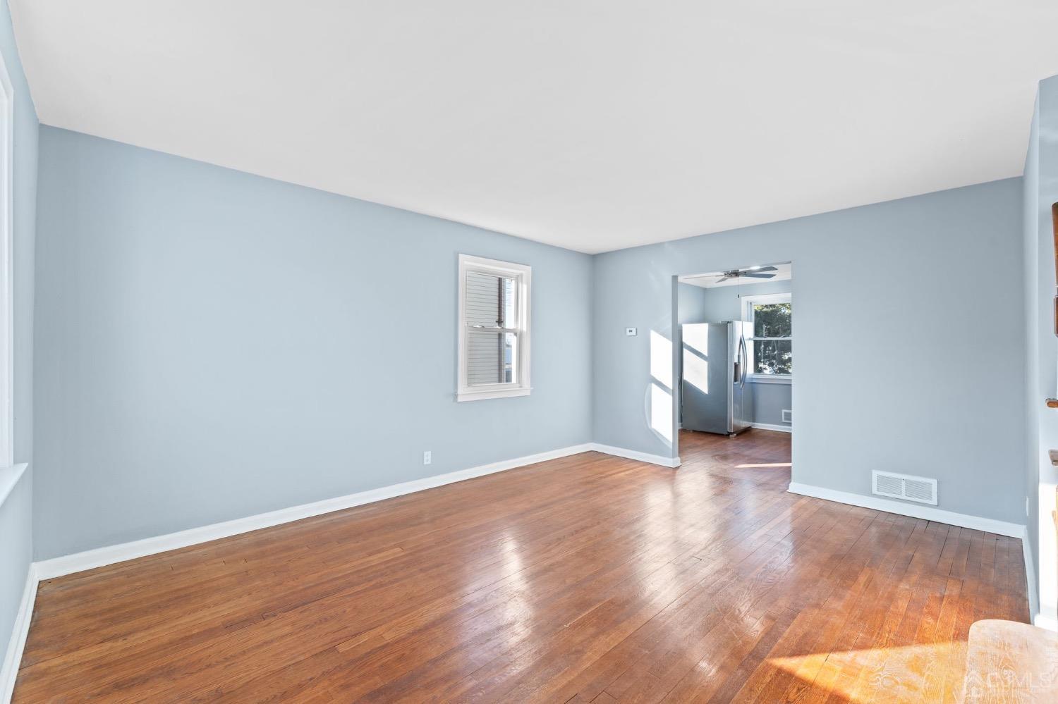 425 Crows Mill Road Fords, NJ 08863 - Photo 3 of 16 a view of a big room with wooden floor and windows