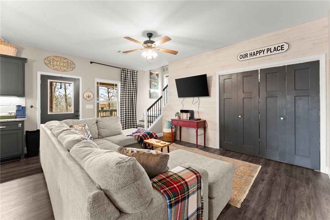 97 Cherokee Road Toccoa, GA 30577 - Photo 11 of 30 This living room features dark wood flooring, an exterior door, and convenient closet storage.