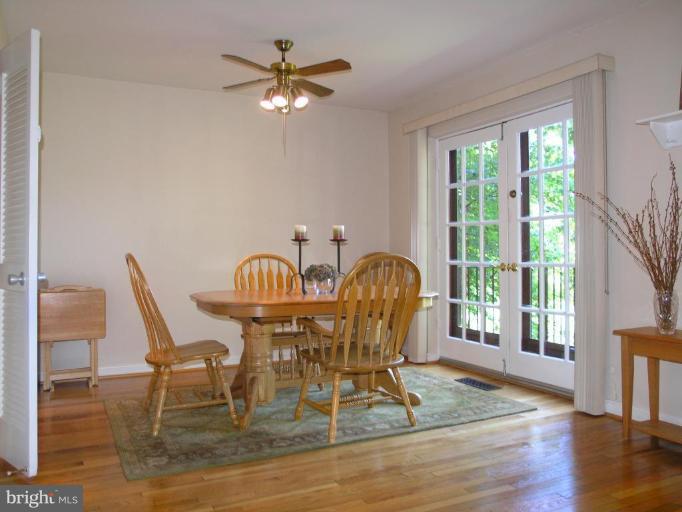 2074 Golf Course Drive Reston, VA 20191 - Photo 11 of 30 a view of a dining room with furniture a chandelier and wooden floor