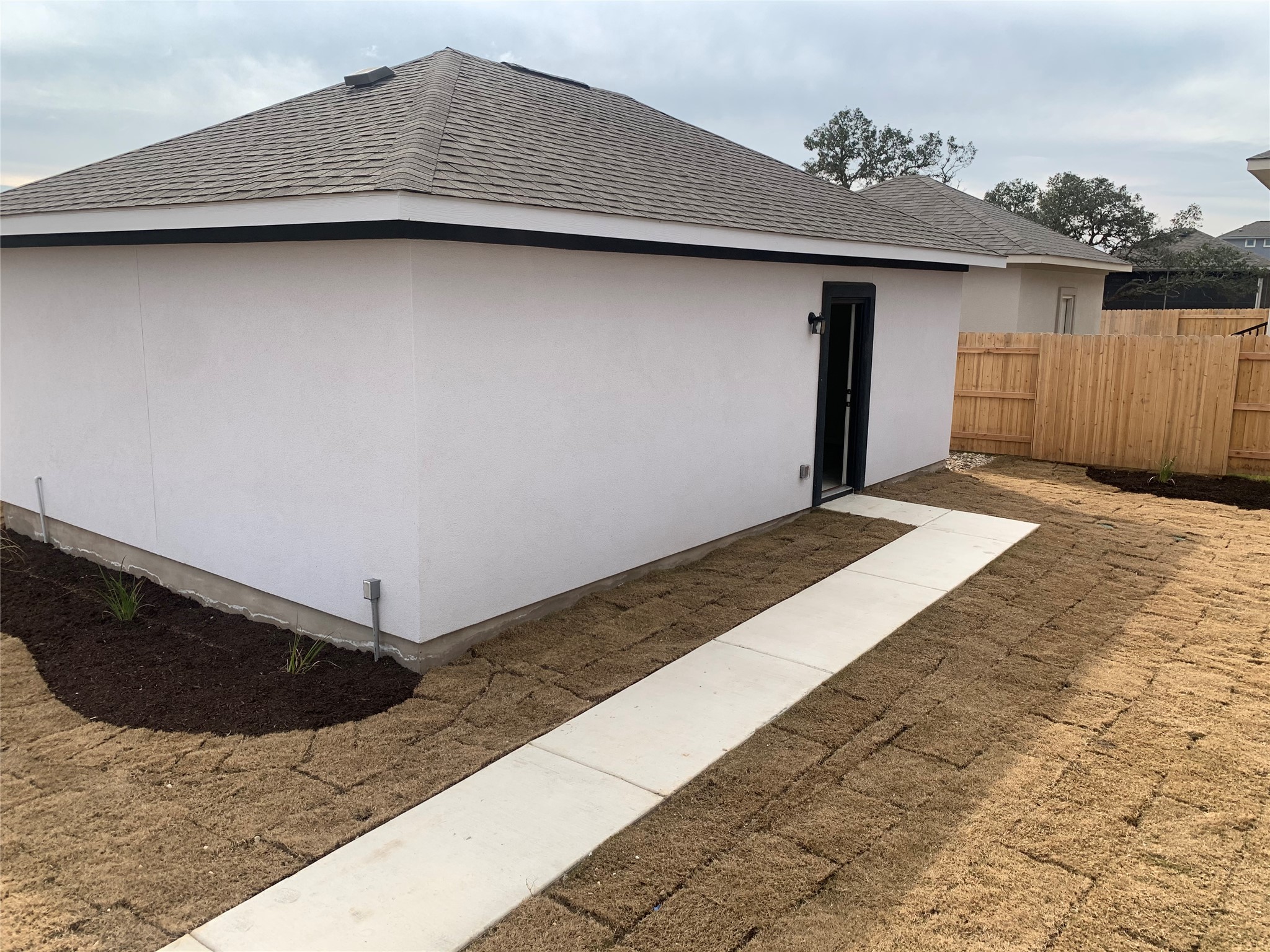 2948 Sage Ranch Drive Leander, TX 78641 - Photo 26 of 28 A newly sodded yard wraps around a pristine modern home with a private entrance.