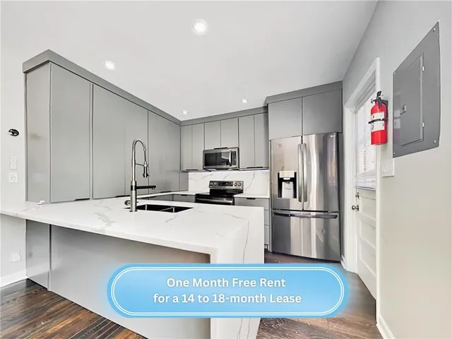 a kitchen with stainless steel appliances granite countertop a sink refrigerator and microwave