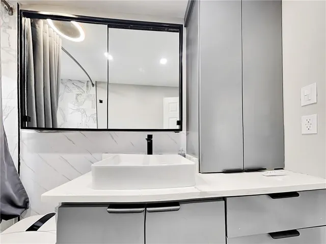 a bathroom with a sink and a mirror