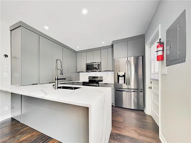 a kitchen with refrigerator cabinets and wooden floor