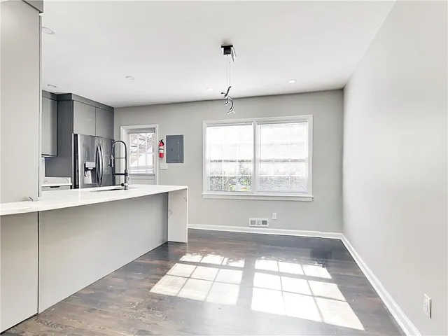 a view of bathroom with windows and dual sinks