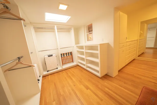 a view of a room with wooden floor and white walls