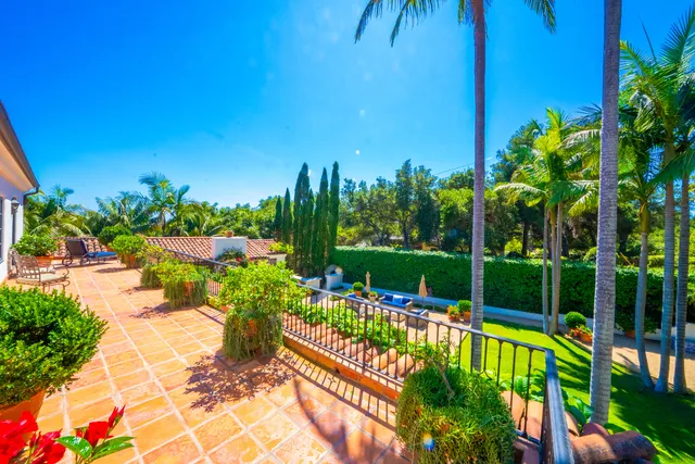 a view of a fountain with a bench in a patio