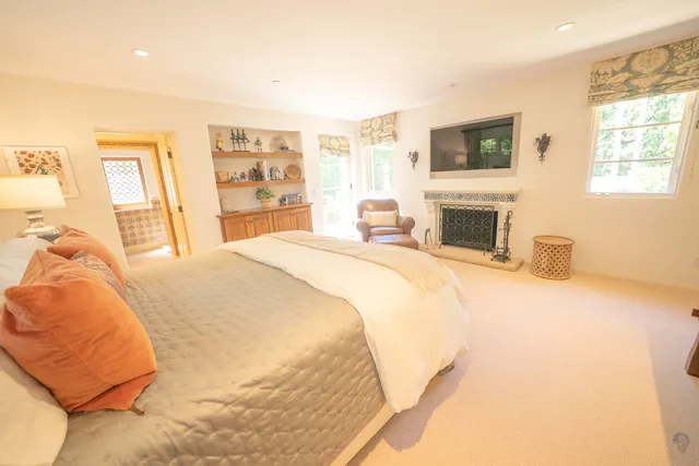 a spacious bedroom with a bed and a fireplace