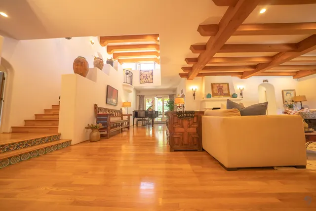 a living room with lots of furniture and a large window