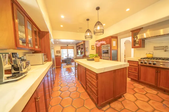 a kitchen with stainless steel appliances granite countertop a stove and a sink