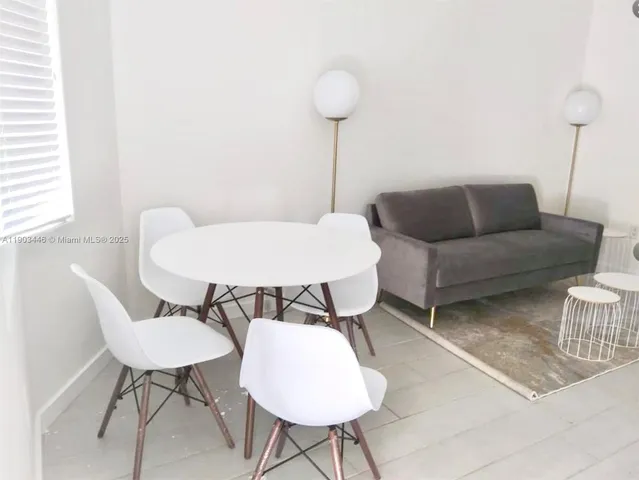 a living room with furniture and a lamp