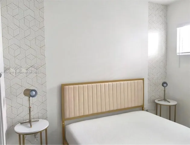 a bedroom with a bed and a table