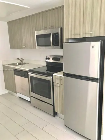 a kitchen with a refrigerator sink and microwave