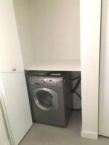a utility room with washing machine